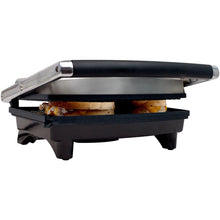 Panini press indoor grill with lid closed, black base and silver handle
