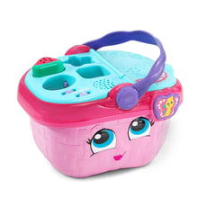 Pink toy picnic basket with purple handle and close-up of teal activity tray