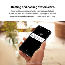 Hand holding smartphone showing thermostat alert notification