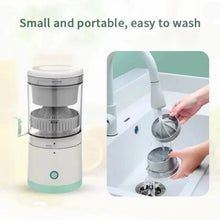 Automatic citrus juicer with removable pulp strainer being rinsed in a sink
