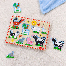 Farm animal sound puzzle board with peg pieces scattered around on the floor