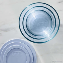 Pyrex storage lids and tinted round bases, top view with blue rims