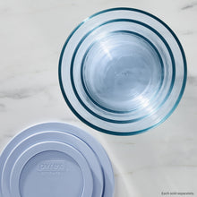 Blue tinted round storage container with lid, close-up view