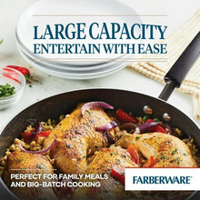 Black covered jumbo cooker with glass lid shown and food inside