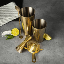 Gold cocktail bar tool set with jigger, shaker, bar spoon, citrus strainer