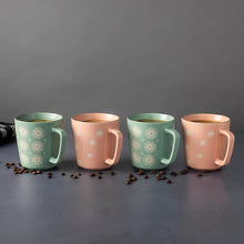 Four starburst mugs, two mint green and two blush pink, each with a C-shaped handle