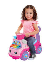 Kids push ride-on car in pink with light-up music console and smiling wheels