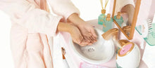 Kids spa play set sink with faucet, soap-like piece, and small bottle accessories