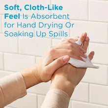Soft white paper towel in hands for hand drying