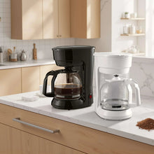 Black 12-cup drip coffee maker on kitchen countertop with glass carafe