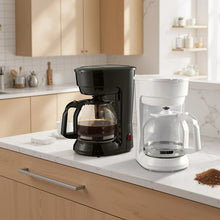 Black coffee maker next to white coffee maker, both with glass carafes