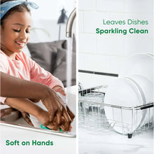 Green Palmolive dish soap bottle being used for dishwashing with foam on dishes
