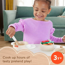 Wooden pots and pans set with stacked cookware and colorful pretend food pieces