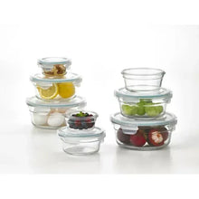 Round glass food storage containers with clear lids, filled with fruit pieces
