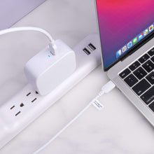 White USB-C laptop charger connected to USB-C cable and laptop charging port