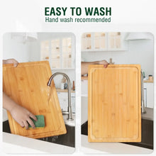 Bamboo cutting board hand washed in sink, showing natural wood surface and rounded edges