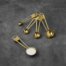 Stainless steel measuring spoon set with five gold spoons and hanging tags