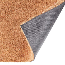 Coir doormat corner with dark gray rubber backing visible