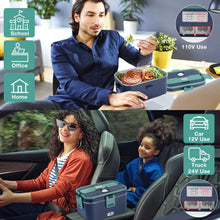Green and royal blue heated lunch box with open lid on desk