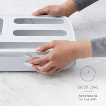 White 5-slot food bag dispenser with hands lifting removable lid for quick refills