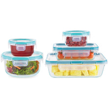 Clear glass storage containers with blue lids holding refrigerated meals