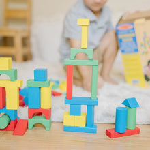 Child playing with colorful wooden blocks, building a tall arch structure.
