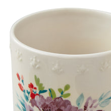 Stoneware stemless wine glass with floral artwork near the rim