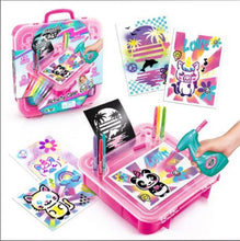 Pink airbrush activity case with open tray, airbrush tool, and included art cards