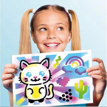Cat-themed craft card held by a child, with colorful stencil-style graphics