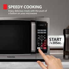 Stainless microwave with digital keypad and hand pressing Start/30 Sec button