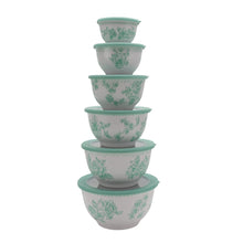 Set of green floral nesting bowls with lids stacked vertically