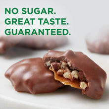 Sugar-free chocolate candy pieces with visible nut filling on a white surface