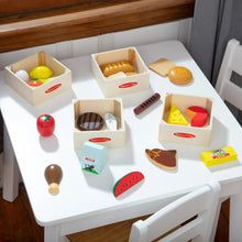 Wooden food groups set on tray with crates and wooden food pieces