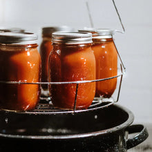 Canning jars on wire rack inside enamel water bath canner pot