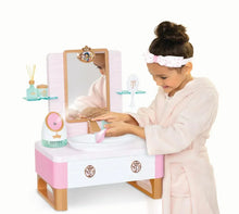 Child using kids spa vanity sink with mirror and countertop accessories