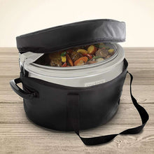 Slow cooker with lid inside black insulated carry bag, showing vegetable-filled insert