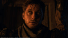 PS5 action game screenshot of a man in dark clothing looking up in a dim room