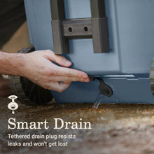 Blue cooler drain spout with tethered drain plug and cap, close-up.