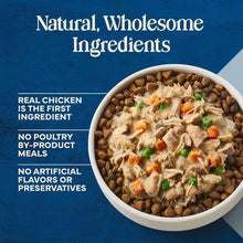 Bowl of dog food with visible chicken, peas, and carrots and kibble pieces