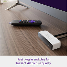 Roku Premiere streaming media player and remote on a tabletop with HDMI cable