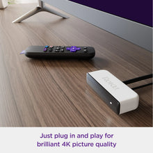 Roku Premiere media player with purple-lit buttons and included white HDMI cable
