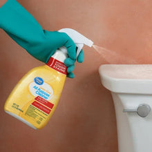 Spraying multi-purpose cleaner onto a countertop surface, yellow bottle and white cap