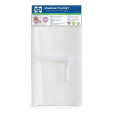 Sealy white contoured changing pad, shown packaged with an adjustable strap