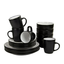 Two-tone coupe dinnerware set with stacked black plates, white bowls, and mugs