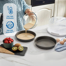Gray round cake pan under clear cake carrier lid