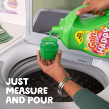 Pouring green Gain Happy liquid detergent into a front-load washing machine