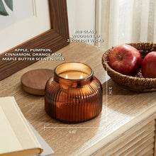 Amber ribbed glass jar candle on wooden tray with lit wicks