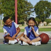 Zbar snack bars in hands of kids during outdoor play on a basketball court