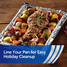 Aluminum foil-lined pan with roasted meat and vegetables