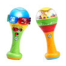 Two learning maracas with blue and green handles, red and yellow buttons, and rattle domes